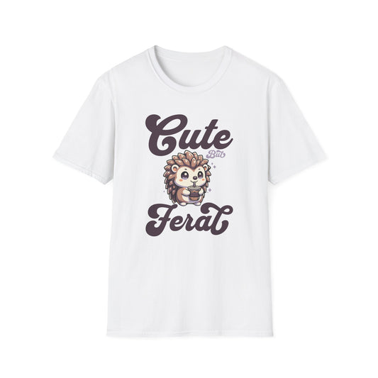 White color t-shirt with ’Cute But Feral’ text on top and bottom of a super cute hedgehog drinking an iced coffee from a to go coffee cup design on a white background
