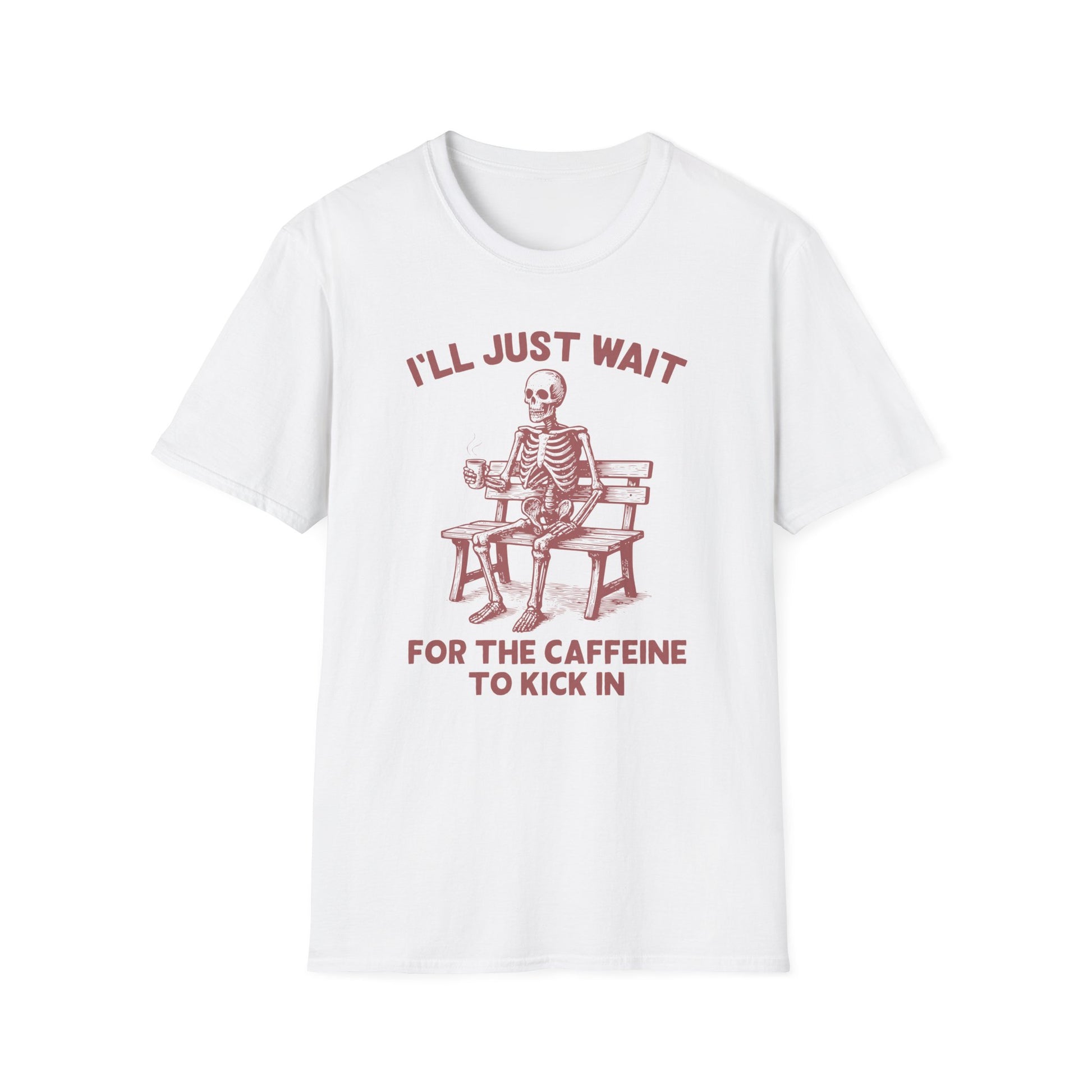 White color t-shirt with ’I’ll Just Wait For The Caffeine To Kick In’ text on top and bottom of a skeleton seating on a wooden bench and holding a freshly made coffee on a mug design on a white background
